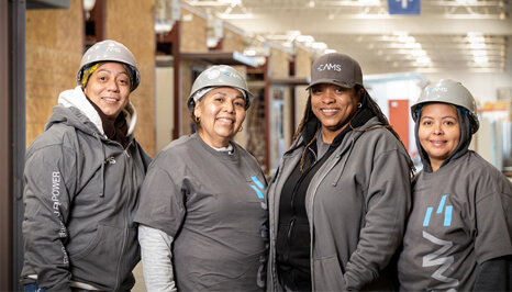 4 women smiling in AMS gear