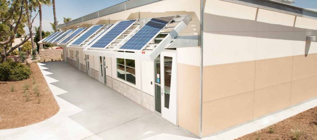 A building with solar panels on the roof, harnessing renewable energy from the sun to power the structure.