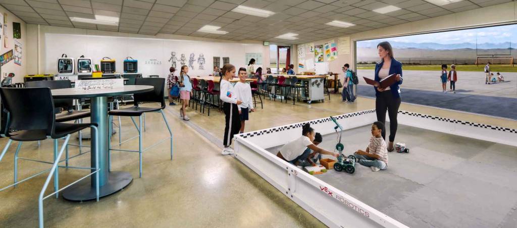 A classroom with a large interactive floor space being used by students for educational purposes.