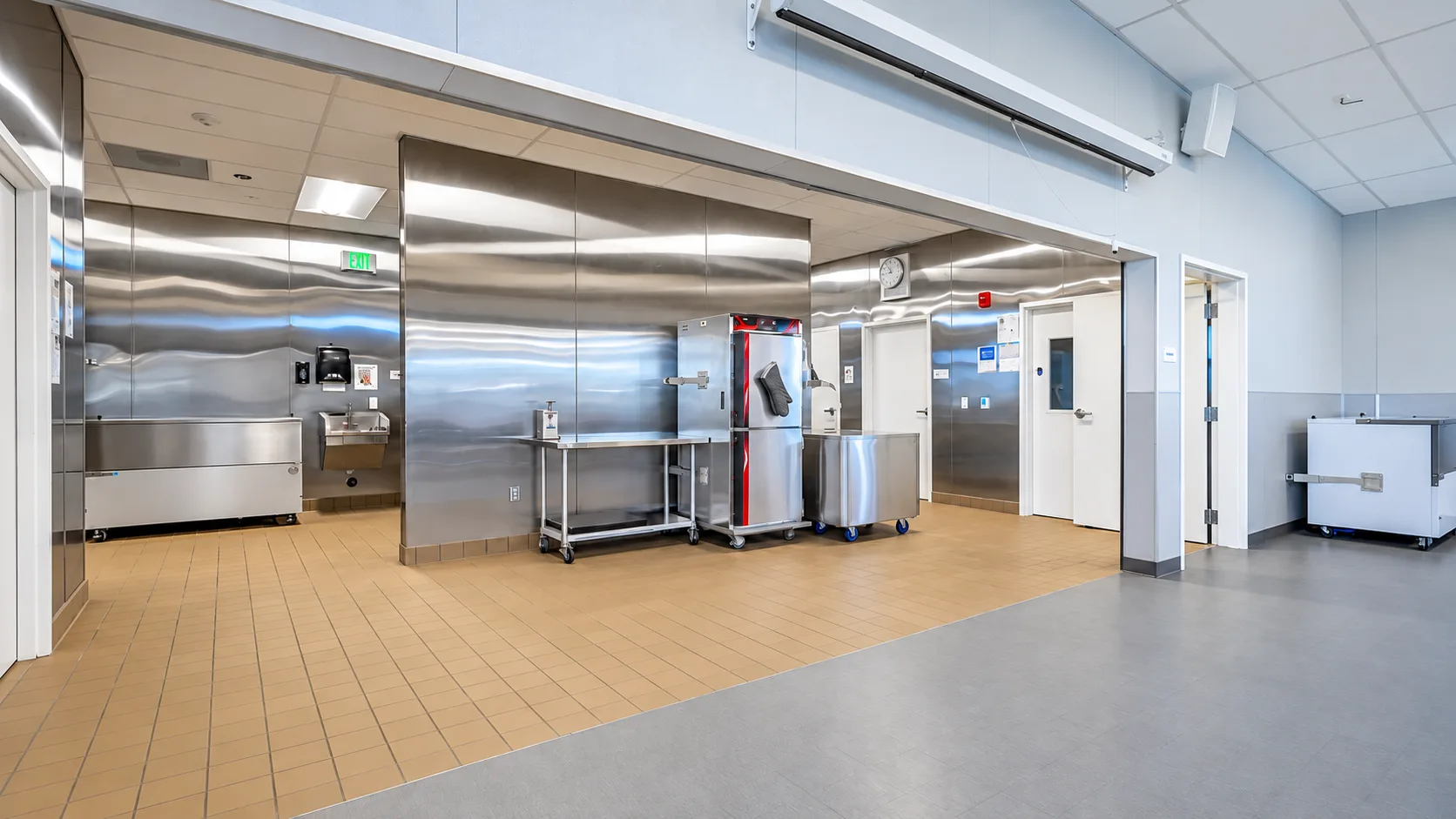 Kitchen at Los Banos Early Education Center with a wide serving opening and stainless surfaces